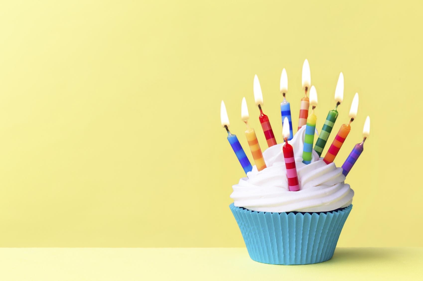 Birthday cupcake against a yellow background