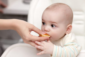 Baby eating cantle of orange