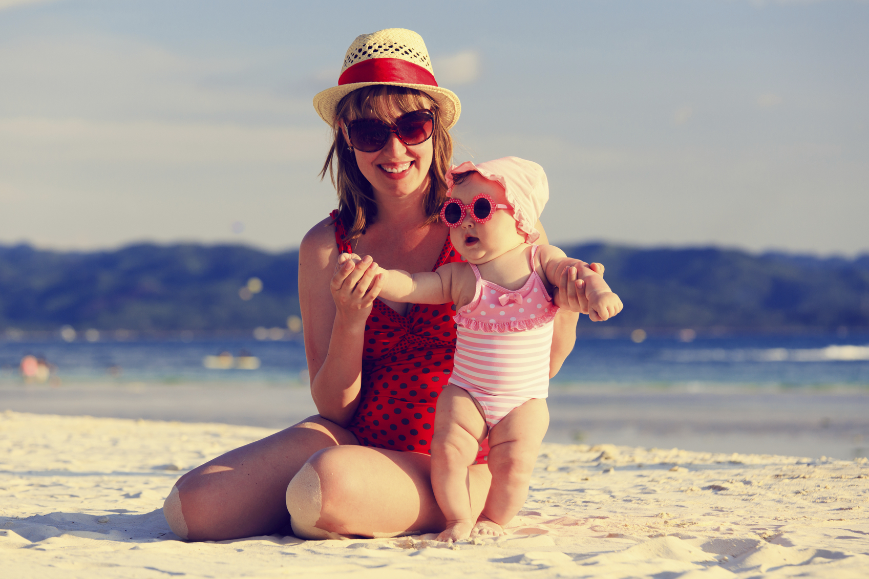mother and little daughter on tropical sand beach