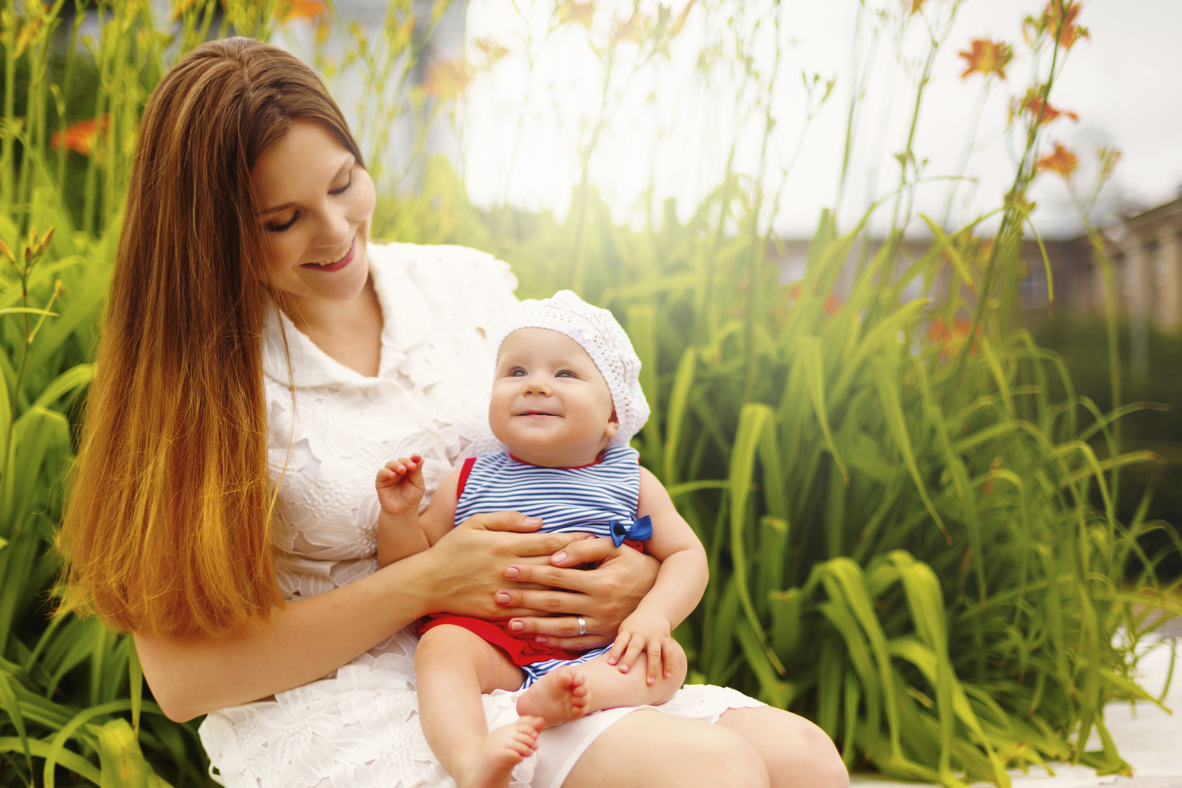 Cute Toddler Baby sitting on Mom`s Hands