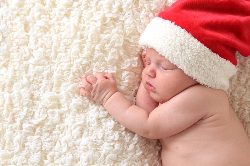 Christmas baby wearing a Santa hat