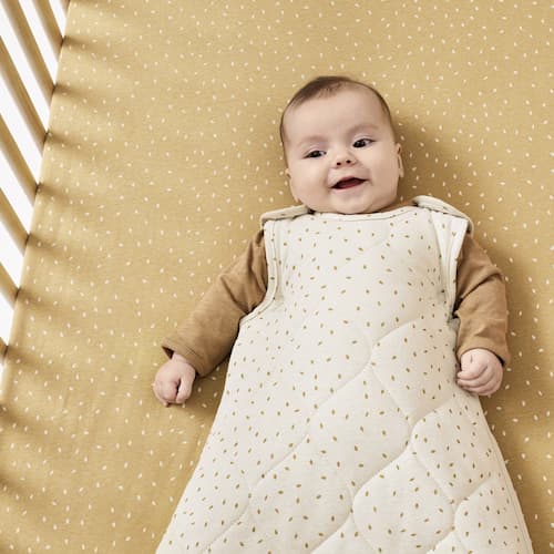 baby smiling in cot