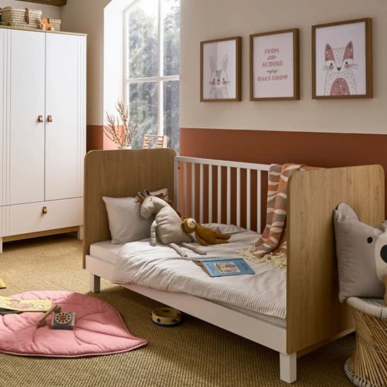 A baby room with a cot and toys