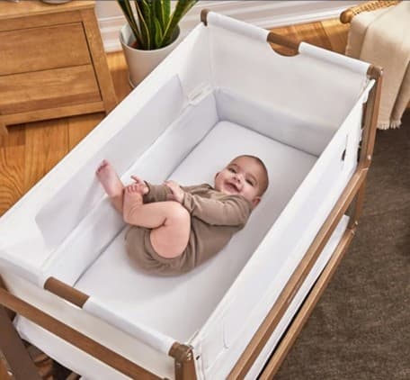 A baby lying in a cot
