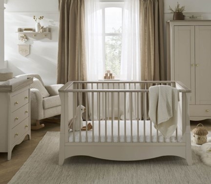 A room with a cot and furniture
