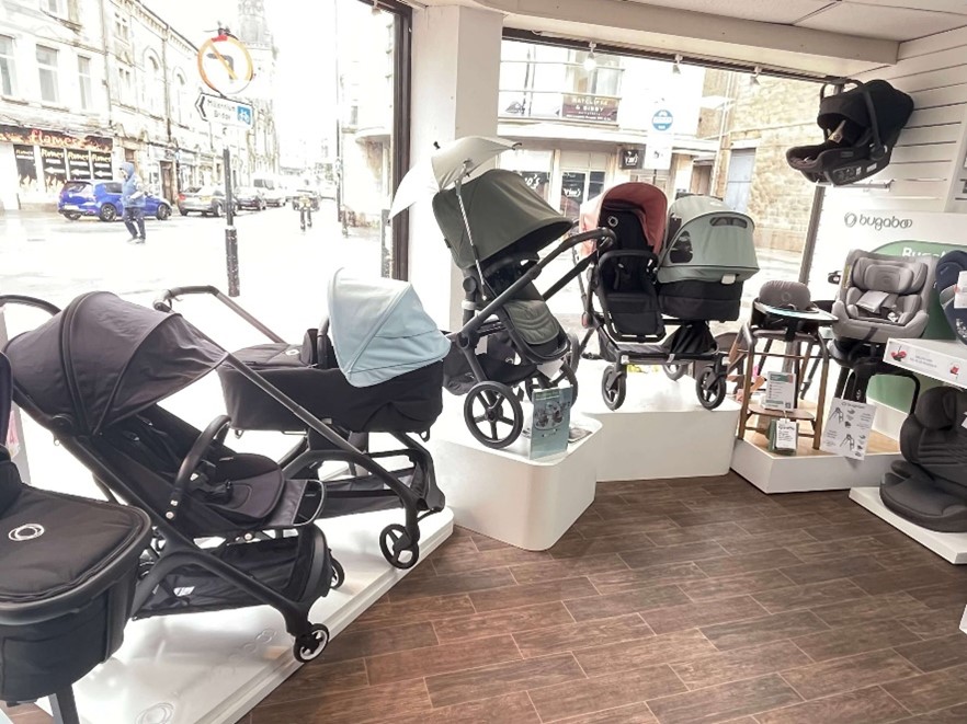 A group of baby strollers in a store